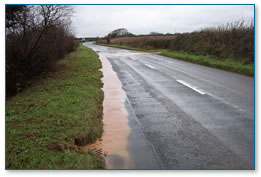 Rainwater flowing into a roadside drain